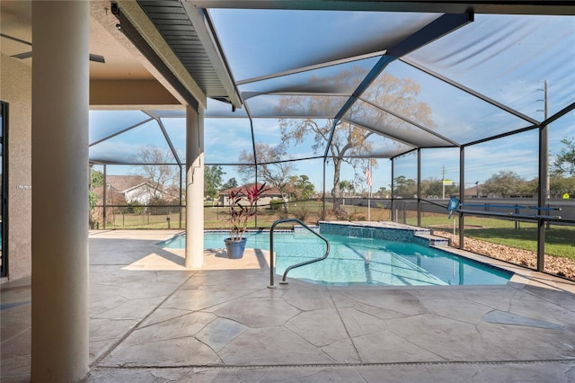 outdoor pool featuring glass enclosure and a patio area