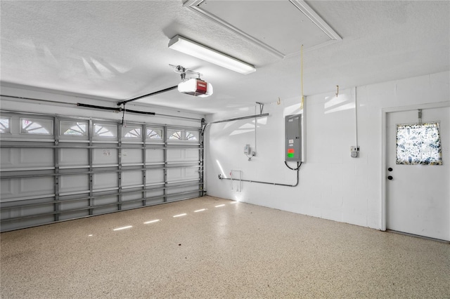 garage featuring a garage door opener, concrete block wall, and electric panel