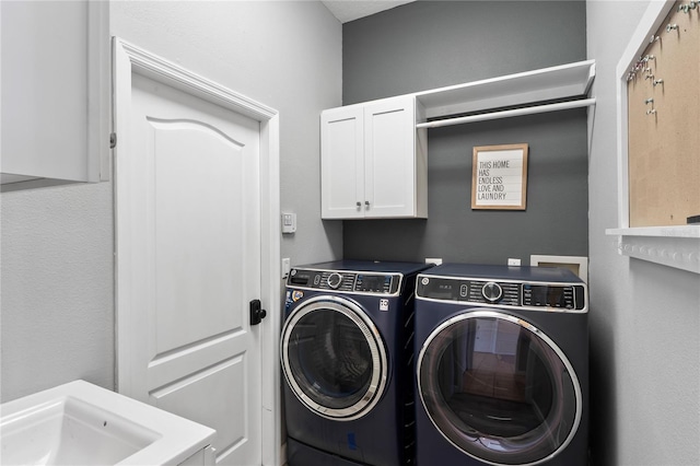 washroom featuring independent washer and dryer and cabinet space