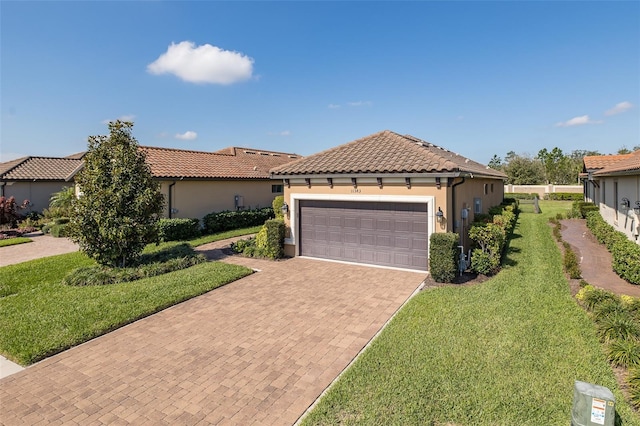 view of front facade featuring decorative driveway, a tile roof, a front lawn, and stucco siding