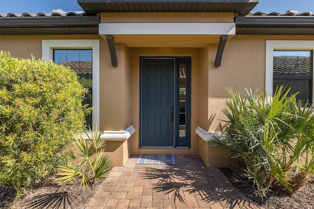 entrance to property with stucco siding