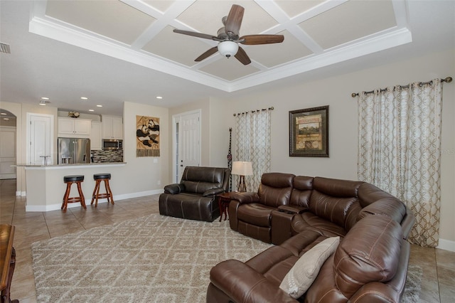 living area with light tile patterned floors, ceiling fan, and coffered ceiling