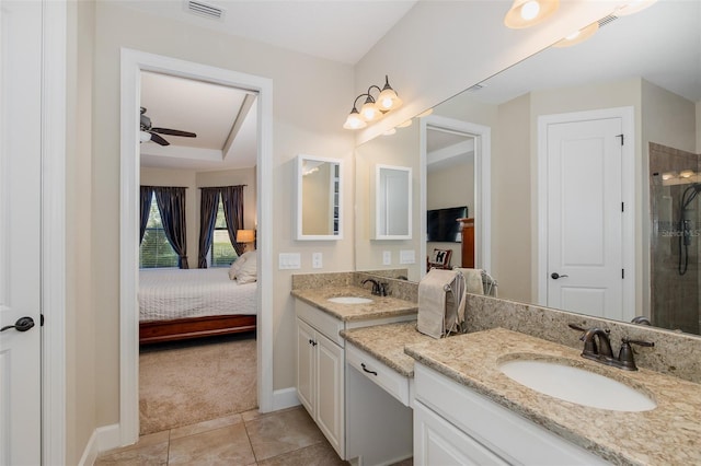 ensuite bathroom featuring baseboards, visible vents, connected bathroom, tile patterned floors, and vanity