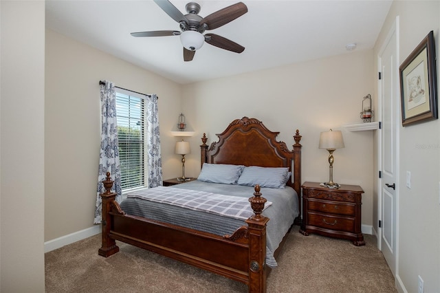 carpeted bedroom featuring ceiling fan and baseboards