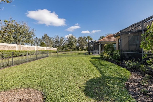 view of yard with a lanai and a fenced backyard