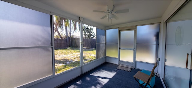 unfurnished sunroom featuring ceiling fan