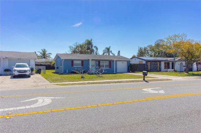 ranch-style home featuring concrete driveway, a front lawn, an attached garage, and fence