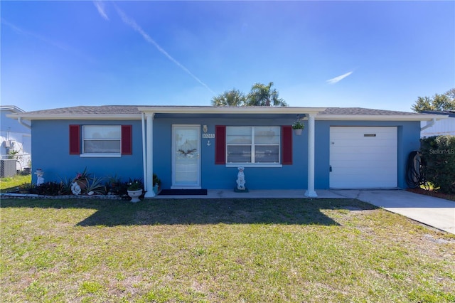 ranch-style home with a front yard, concrete driveway, and stucco siding