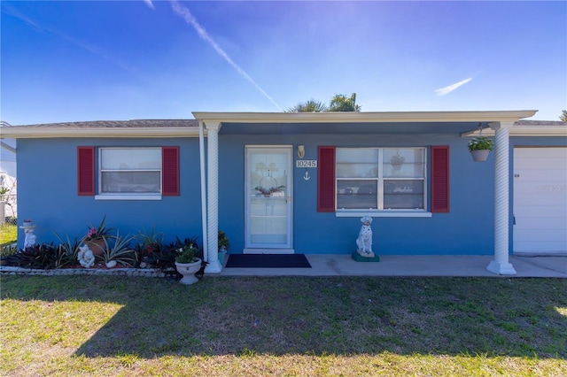 view of front of property with a front lawn and stucco siding