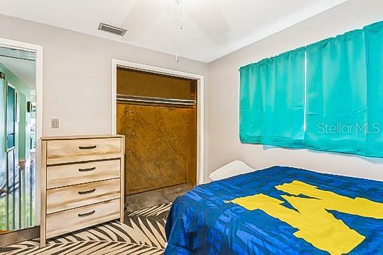 bedroom featuring ceiling fan, a closet, and visible vents