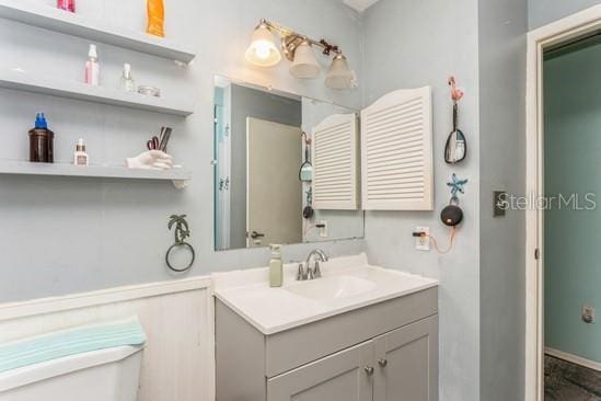 bathroom with vanity and toilet