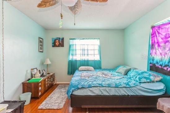 bedroom with ceiling fan and wood finished floors