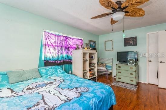 bedroom with ceiling fan and wood finished floors