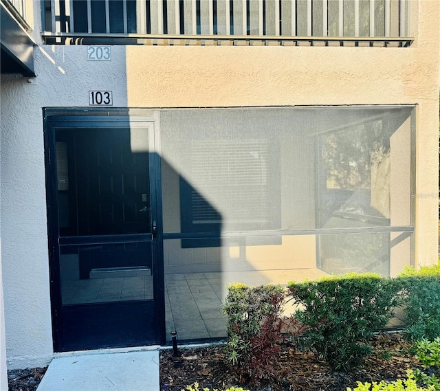 14736 Norwood Oaks Dr Unit 103, Tampa, FL 33613 - view of exterior entry featuring stucco siding
