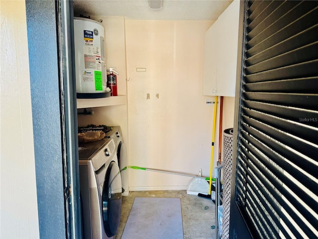 14736 Norwood Oaks Dr Unit 103, Tampa, FL 33613 - clothes washing area with laundry area, water heater, a textured ceiling, and washing machine and clothes dryer