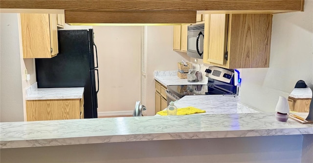 14736 Norwood Oaks Dr Unit 103, Tampa, FL 33613 - kitchen featuring light countertops, black appliances, and light brown cabinetry