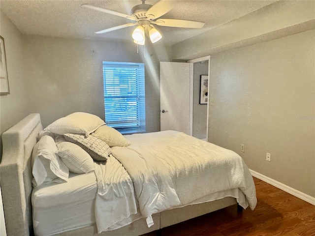 14736 Norwood Oaks Dr Unit 103, Tampa, FL 33613 - bedroom featuring a ceiling fan, a textured ceiling, baseboards, and wood finished floors