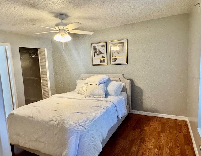 14736 Norwood Oaks Dr Unit 103, Tampa, FL 33613 - bedroom with baseboards, a ceiling fan, wood finished floors, a textured ceiling, and a closet