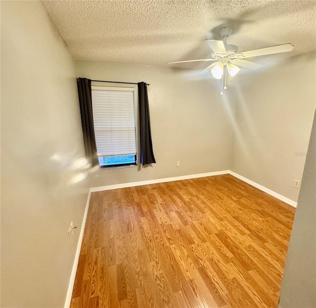 14736 Norwood Oaks Dr Unit 103, Tampa, FL 33613 - spare room featuring ceiling fan, a textured ceiling, baseboards, and wood finished floors