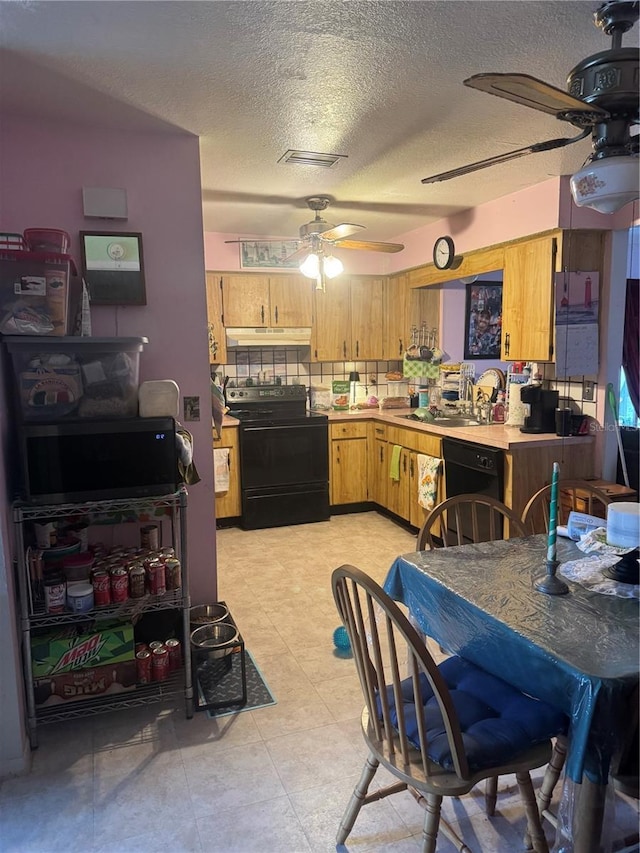 kitchen with tasteful backsplash, ceiling fan, light countertops, black appliances, and a sink