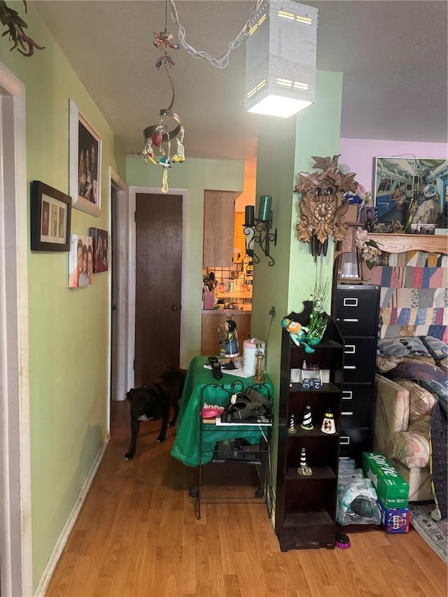 interior space with baseboards and light wood finished floors