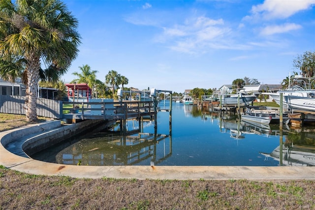 dock area with a water view and boat lift