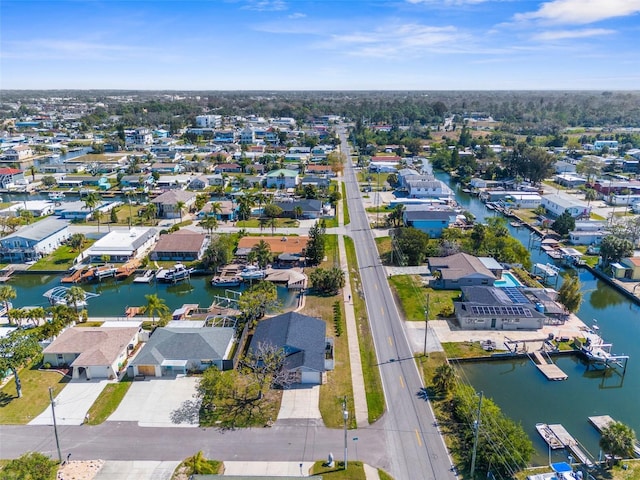 drone / aerial view featuring a water view and a residential view