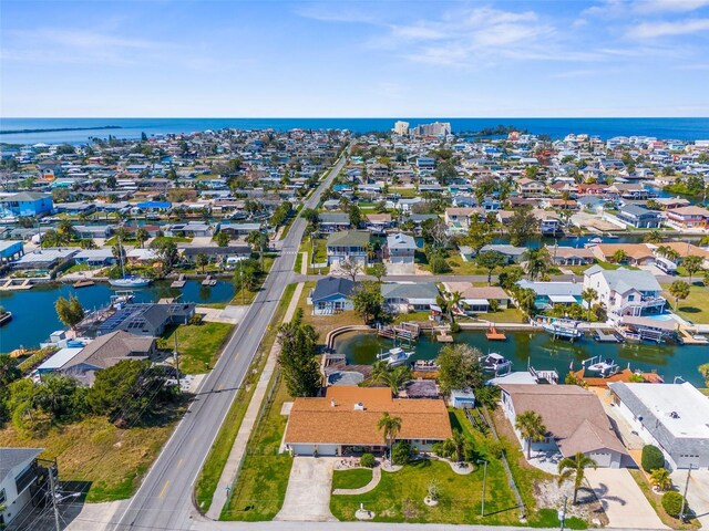 drone / aerial view featuring a residential view and a water view