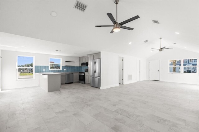 kitchen with visible vents, open floor plan, stainless steel appliances, and gray cabinetry