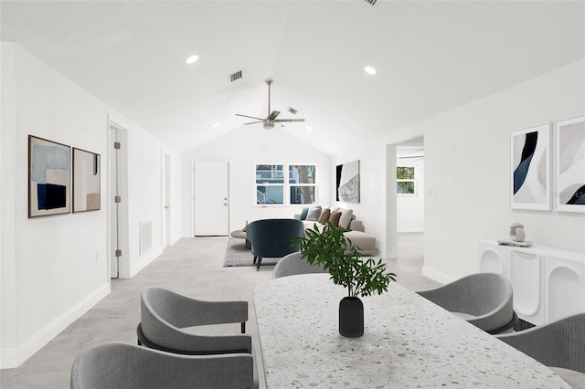 dining room featuring lofted ceiling, ceiling fan, visible vents, and baseboards