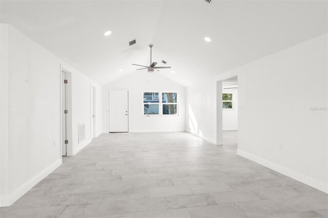 unfurnished room with lofted ceiling, ceiling fan, visible vents, and baseboards