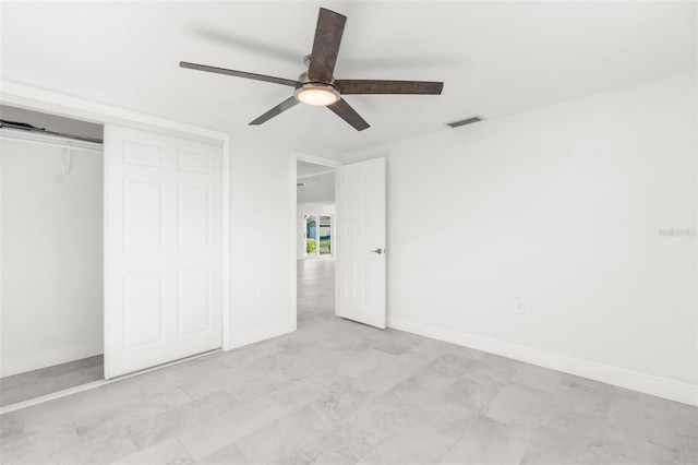 unfurnished bedroom featuring a ceiling fan, baseboards, visible vents, and a closet