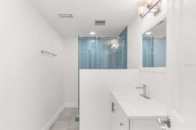 bathroom featuring a stall shower, visible vents, vanity, and baseboards