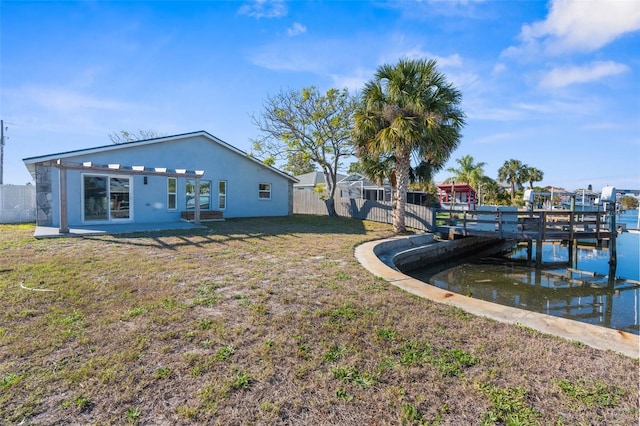 dock area featuring a yard and fence