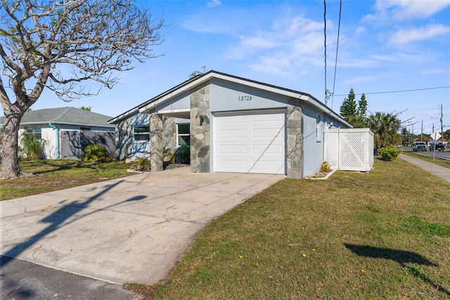 mid-century inspired home featuring driveway, stone siding, fence, and a front lawn