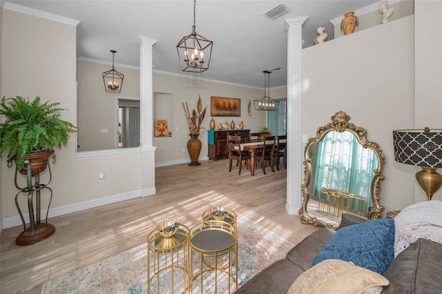 living room featuring a chandelier, wood finished floors, visible vents, ornate columns, and crown molding