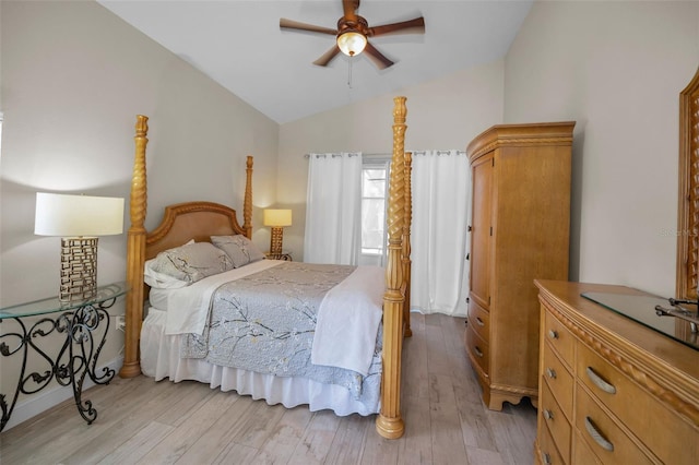 bedroom featuring a ceiling fan, lofted ceiling, and light wood-style flooring