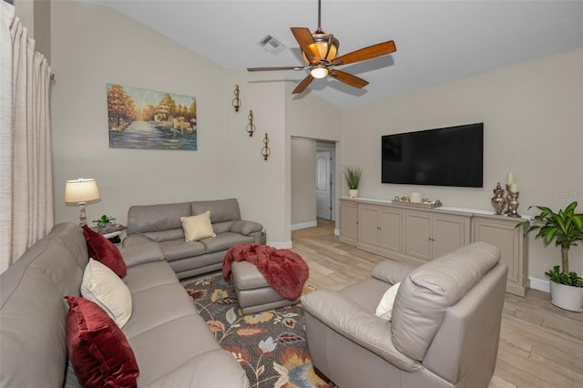 living room featuring light wood-style floors, visible vents, vaulted ceiling, and a ceiling fan