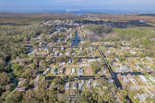 6183 Waverly Rd, Weeki Wachee, FL 34607 - aerial view of property and surrounding area featuring nearby suburban area, property boundaries highlighted, and a forest
