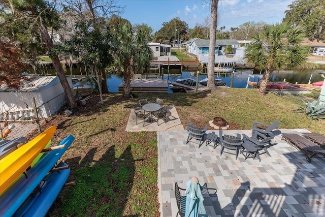 6183 Waverly Rd, Weeki Wachee, FL 34607 - view of green lawn with a patio area, a water view, a fire pit, a dock, and boat lift