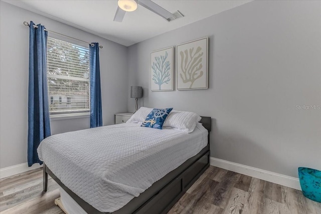 6183 Waverly Rd, Weeki Wachee, FL 34607 - bedroom featuring baseboards, wood finished floors, and a ceiling fan