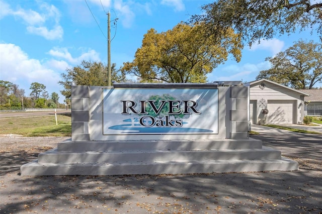 community / neighborhood sign featuring a garage