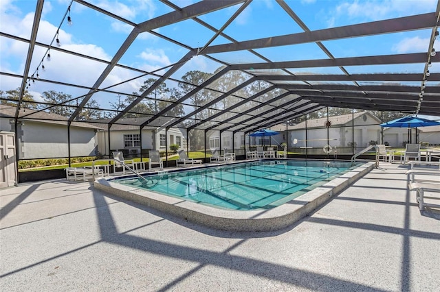 community pool with glass enclosure and a patio