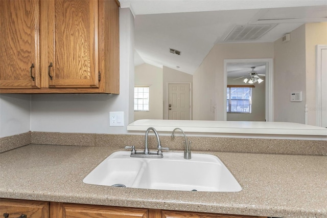 kitchen with visible vents, brown cabinets, a healthy amount of sunlight, and a sink