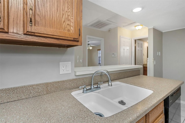 kitchen featuring visible vents, light countertops, black dishwasher, and a sink