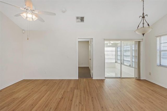 unfurnished room with visible vents, lofted ceiling, light wood-style floors, and ceiling fan