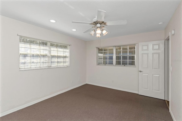 spare room featuring recessed lighting, a ceiling fan, baseboards, and dark colored carpet