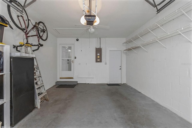 garage with electric panel, a garage door opener, and a ceiling fan