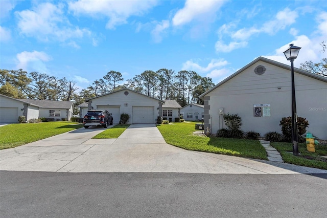 ranch-style house with stucco siding, a garage, concrete driveway, and a front yard