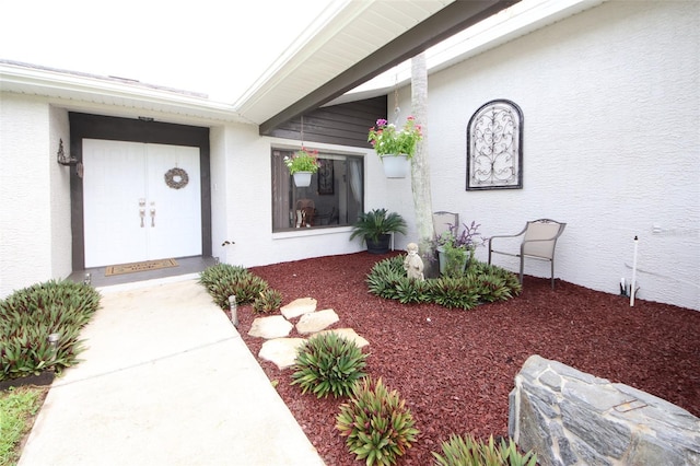 property entrance with stucco siding